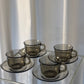 Set of 4 Arcoroc smoked glass coffee cups and saucers