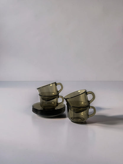 Set of 4 Arcoroc smoked glass coffee cups and saucers